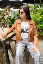 Woman in brown jacket wearing Simply Love full size letter graphic short sleeve T-shirt