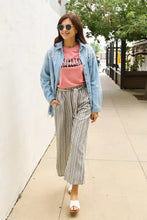 Woman in Simply Love Motivated Mompreneur short sleeve t-shirt and casual outfit