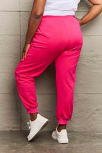 Simply Love full size pink graphic sweatpants with white sneakers