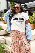 Simply Love short sleeve t-shirt on plus-size woman in denim jacket and polka-dot pants