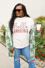 Woman in Simply Love long sleeve green white buffalo plaid cardigan and cream Hello Christmas tee holding coffee cup