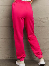 Simply Love hot pink size drawstring sweatpants with neon pink joggers and white sneakers