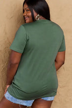 Simply Love mom life graphic short sleeve cotton t-shirt in olive green with frayed denim shorts and hoop earrings