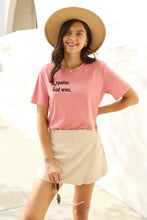 Simply Love pink short-sleeve Spoiler God Wins T-shirt with tan skirt and straw hat