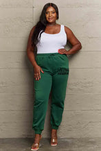 Simply Love womens dark green jogger sweatpants on plus size model