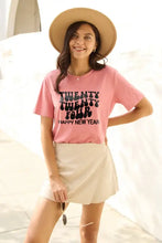 Woman in Simply Love year short sleeve pink four happy New Year graphic t-shirt