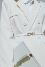 White double-breasted trench coat with gold buttons and skinny belt buckle