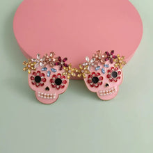 Two pink skull rhinestone alloy earrings with colorful gems and pearls