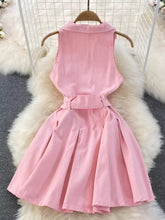 Soft pink sleeveless belted denim dress with collar and pleated skirt featuring a matching waist belt