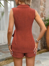 Rust-colored sleeveless blazer with textured fabric and tie waist detail
