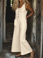 Cream-colored sleeveless button front wide leg jumpsuit