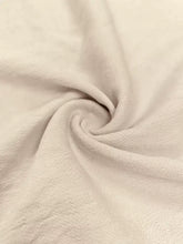Cream-colored ribbed knit fabric in sleeveless button front wide leg jumpsuit