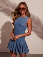 Sleeveless blue denim dress with fitted bodice, pleated skirt, and bow tie denim cutout back design
