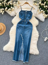 Blue denim dress with thin straps, button-front detailing, and a sleeveless frayed hem slit down the front