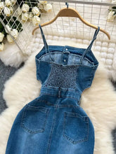 Blue denim sleeveless frayed hem dress featuring strapless smocked bodice and front button closure