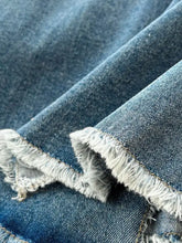 Blue denim sleeveless frayed hem slit dress featuring white-washed edges and frayed hem detail