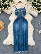 Blue denim dress featuring a sleeveless frayed hem and smocked bodice with a frayed hem detail