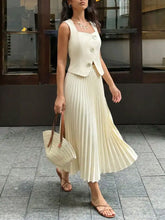 Cream-colored pleated midi skirt with fitted button-front sleeveless vest top