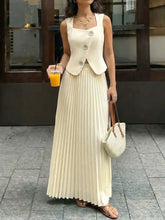 Cream-colored pleated maxi skirt with fitted buttoned sleeveless vest bodice set