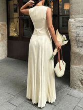 Cream-colored sleeveless vest and pleated maxi skirt set, fitted bodice view