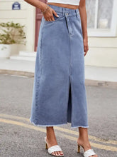 Light-wash denim skirt with slit asymmetrical waist front slit and frayed hem ideal for casual wear