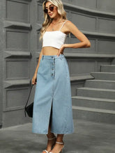 Light blue denim midi skirt with front button closure and high slit featuring slit button detail denim midi skirt design