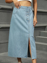 Light blue denim midi skirt with front button closure and side slit in a stylish denim midi skirt design