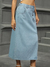 Light-wash denim midi skirt with button front closure and side slit showcasing classic denim midi skirt style