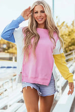 Woman in slit contrast round neck long sleeve sweatshirt and denim shorts