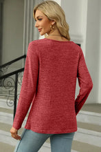 Woman in red marled long-sleeve square neck T-shirt with decorative button