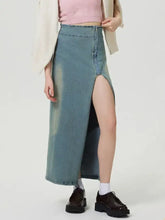 A high-waisted faded blue denim skirt with a front zipper and thigh-high slit slit denim skirt