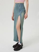 High-waisted light blue wash denim skirt with front zipper and thigh-high slit slit denim skirt for stylish wear