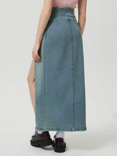 A high-waisted light blue denim skirt with a front slit and visible stitching details slit denim skirt with zip