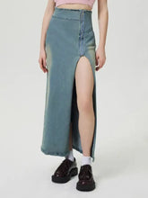 A faded blue wash high-waisted slit denim skirt with zip detail and frayed hem in durable denim material