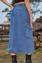 Blue denim midi skirt with slit front, multiple cargo pockets, and elastic waistband for casual wear
