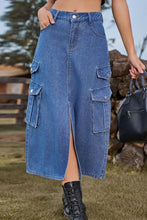 Blue denim midi skirt with multiple flap pockets and a front slit for stylish casual wear