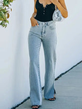 Light-wash denim slit hem bootcut jeans with high waist and side slit detail for a stylish flare look