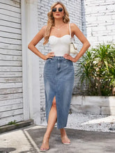 A slit midi denim skirt in blue with waist stretch, front slit, classic stitching, and functional pockets