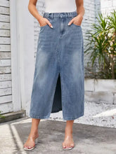 Slit midi denim skirt in medium wash blue with waist stretch elastic waistband front slit and pockets design