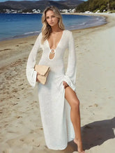 Woman in white knit maxi plunge flare sleeve dress with slit