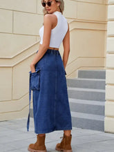 Blue denim high waist skirt with drawstring waist slit pockets and midi length made of denim fabric