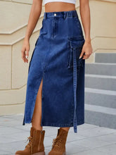 Mid-thigh length high waist denim skirt with side slit and large cargo pockets in classic blue denim material