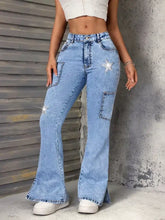 Light-wash denim slit star flare leg jeans with sparkling star embellishments on front pockets and thigh