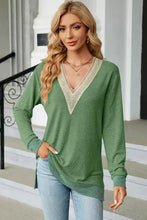 Long sleeve green tunic with cream lace V-neck and slit hem