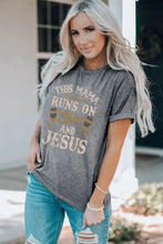 Woman’s gray short-sleeved slogan graphic round neck tee with distressed light blue jeans