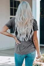 Woman with long wavy platinum blonde hair in slogan graphic round neck tee
