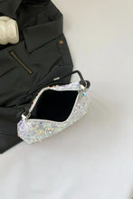 Silver sequin shoulder bag with black handle and zipper, polyester imported