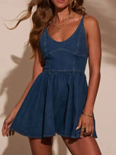 A fitted medium-wash blue denim mini dress with smocked back adjustable straps and a flared skirt