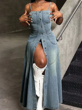 A stylish smocked button front denim cami dress with thin straps and a high slit showing white boots