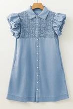 Light blue denim dress with smocked collared neck, ruffled puff sleeves, and button-front design